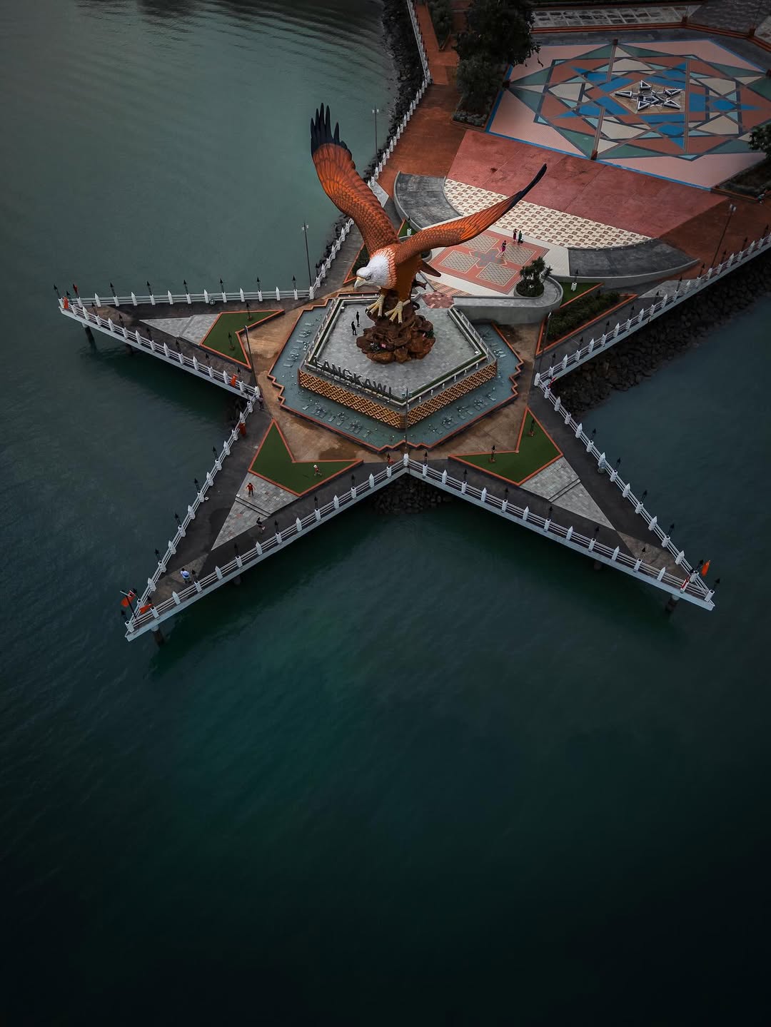 Aerial view of the eagle statue at Dataran Lang in Langkawi, set on a star-shaped platform extending into the sea.
