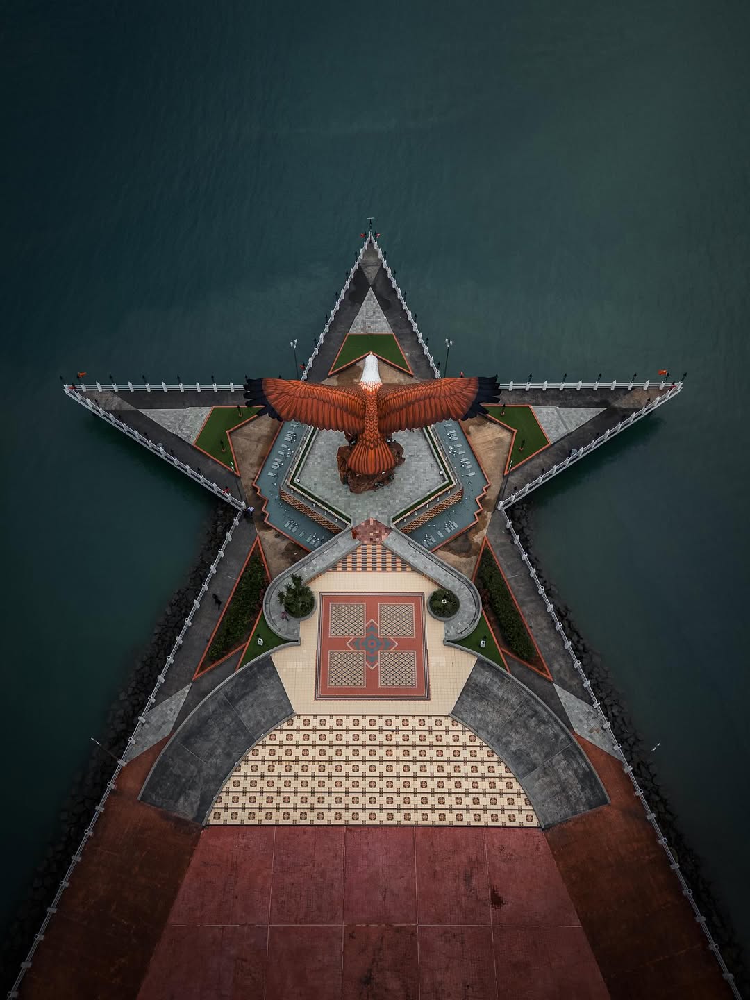 Aerial view of Dataran Lang in Kuah Town Langkawi featuring the iconic eagle statue on a star-shaped platform over the sea.