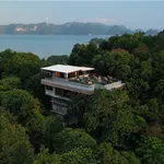 Ambong Ambong Rainforest Retreat featuring a luxury hillside retreat surrounded by lush rainforest, a modern elevated building with a rooftop terrace, and panoramic views of the Andaman Sea in Langkawi.
