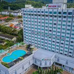 Bayview Hotel Langkawi featuring a modern high-rise hotel with a rooftop outdoor swimming pool, spacious city-view accommodations, and a convenient location in Kuah Town surrounded by hills and urban attractions.