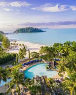 Aerial view of Berjaya Langkawi Resort with a tropical pool, palm trees, sandy beach, and a small island in the distance.