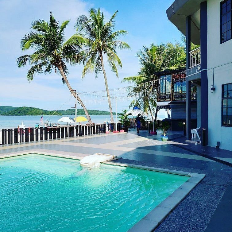 Best Star Resort Langkawi featuring a beachfront swimming pool, tropical palm trees, modern resort accommodations, and panoramic views of the Andaman Sea in a relaxed island setting.