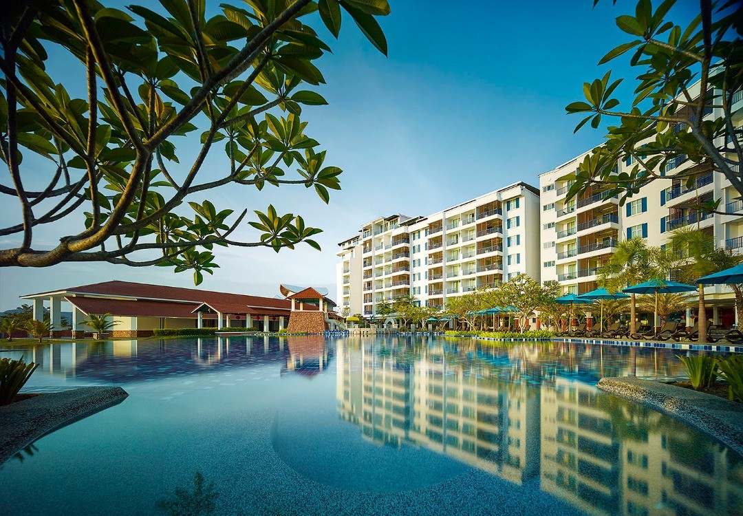 Dayang Bay Resort Langkawi featuring a spacious lagoon-style infinity pool, modern waterfront accommodations, tropical landscaping, and scenic views overlooking Kuah Bay in a relaxing resort setting.