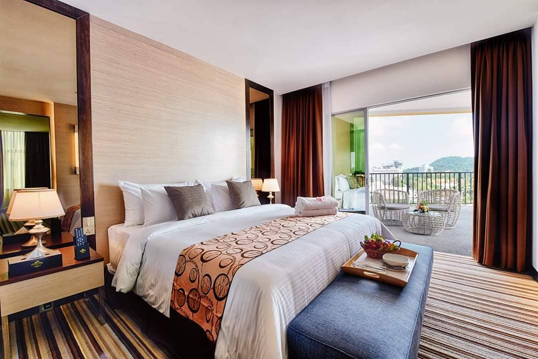 Goldsands Hotel Langkawi featuring a modern guest room with a king-size bed, stylish contemporary furnishings, a private balcony with mountain views, and spacious accommodations in Kuah Town.