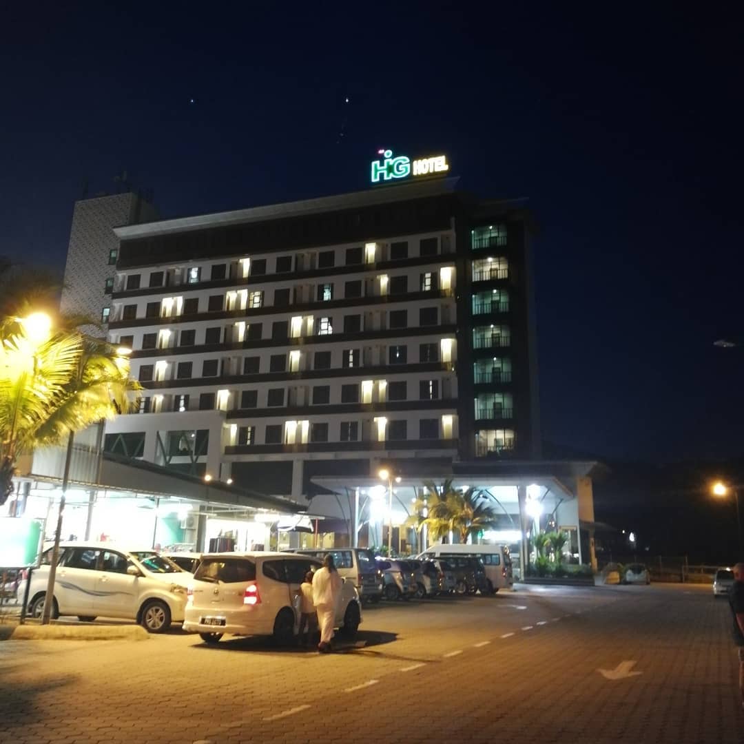 HIG Hotel & Convention Langkawi featuring a modern multi-story hotel illuminated at night, with contemporary accommodations, on-site convention facilities, ample parking, and a convenient location in Kuah Town.