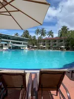 Holiday Villa Resort & Beachclub Langkawi featuring a large freeform outdoor swimming pool surrounded by palm trees, sun loungers, tropical gardens, and low-rise beachfront accommodations near Pantai Tengah.