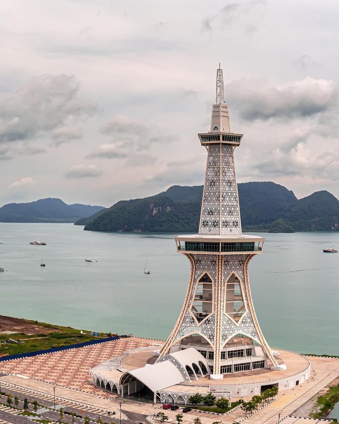 MAHA Tower in Kuah Town Langkawi overlooking the sea with surrounding mountains and boats in the distance.