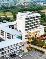 Mercure Langkawi Pantai Cenang featuring a modern mid-rise hotel with contemporary architecture, spacious guest accommodations, landscaped gardens, and panoramic views of Pantai Cenang and the surrounding countryside.
