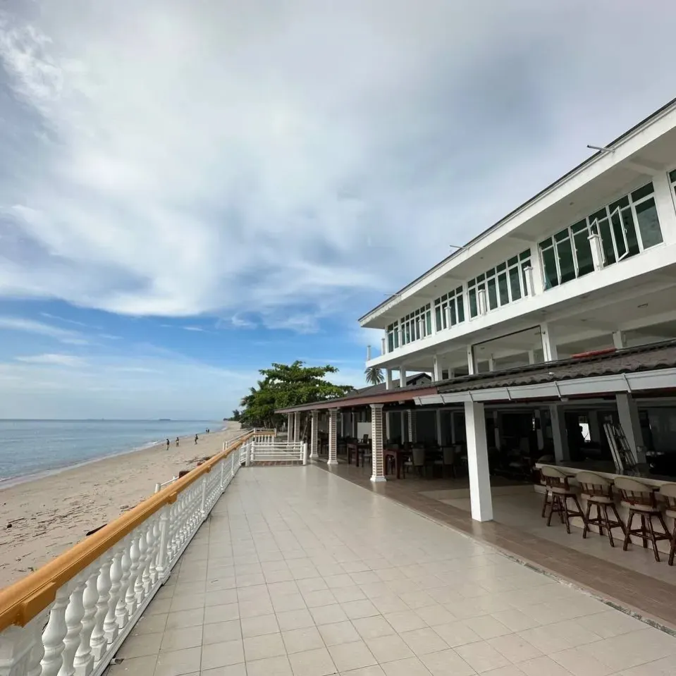 Nazrat Residence (Labu Labi Residence) Langkawi featuring a beachfront hotel with an open-air terrace, direct beach access, spacious dining area, and panoramic views of the Andaman Sea in a peaceful coastal setting.
