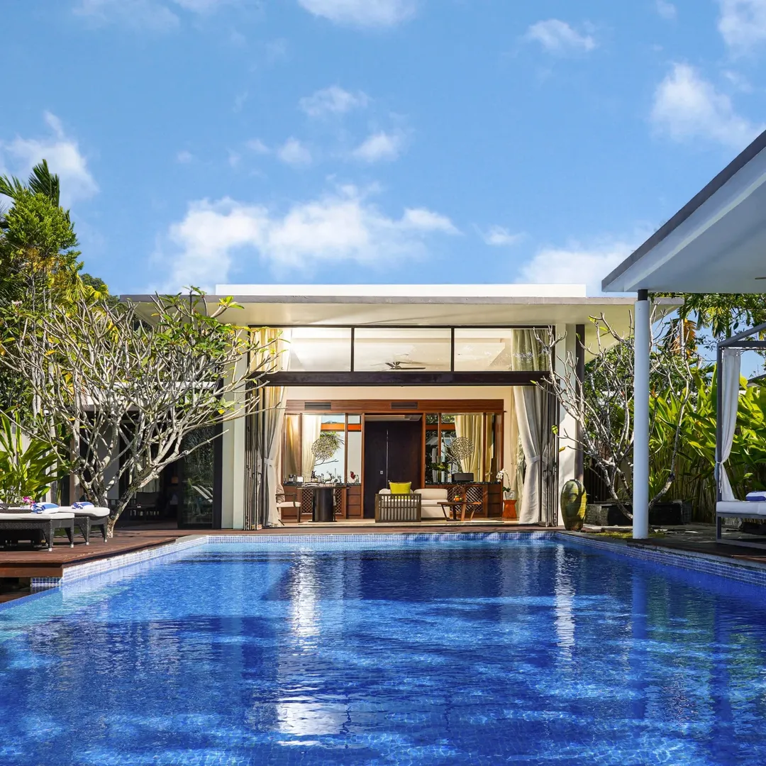 Luxury private pool villa at The Danna Langkawi featuring a spacious infinity pool, modern tropical design, and open living area surrounded by greenery.