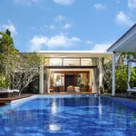 Luxury private pool villa at The Danna Langkawi featuring a spacious infinity pool, modern tropical design, and open living area surrounded by greenery.