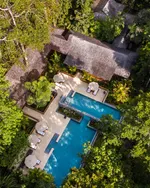 Aerial view of The Datai Langkawi villa with a private pool surrounded by dense tropical rainforest and lush greenery.