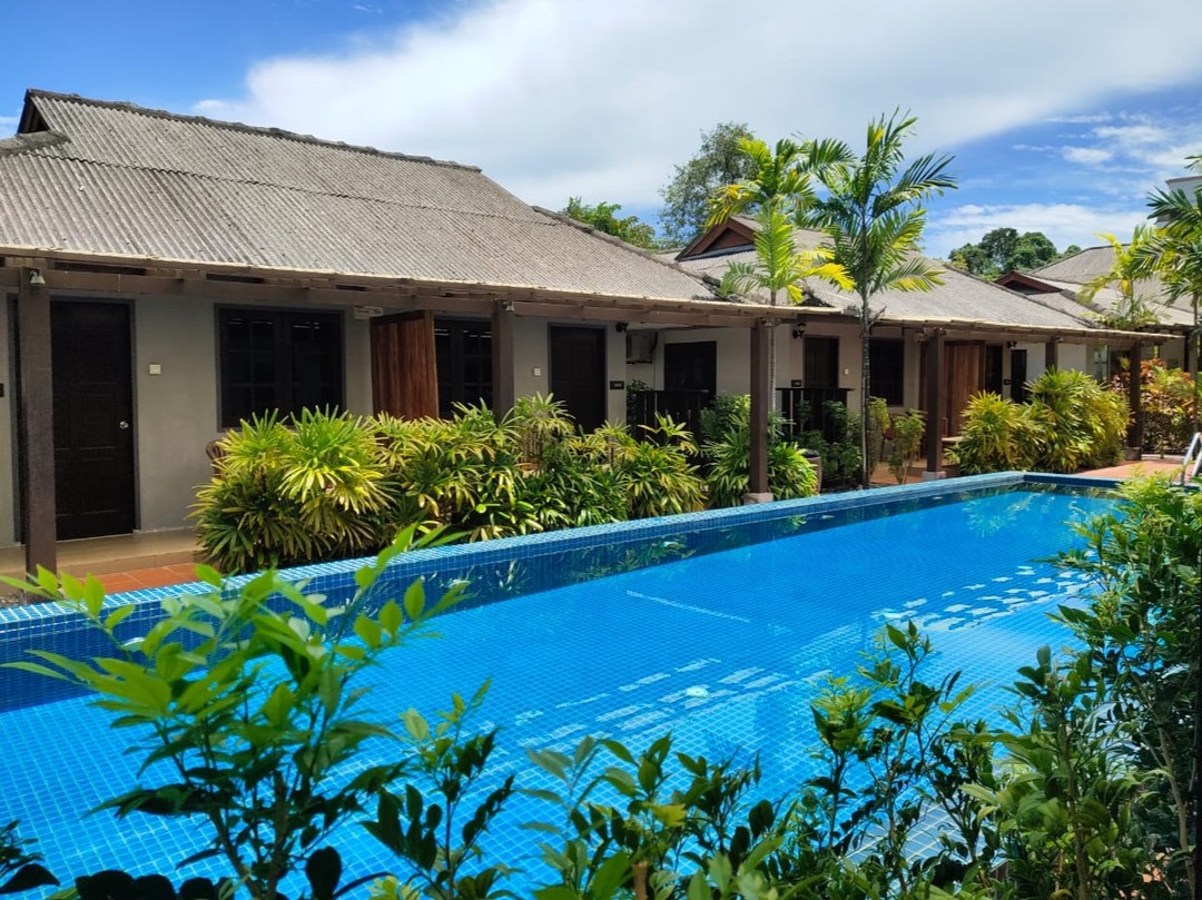 Tropical Resort Langkawi featuring a peaceful boutique resort with a long outdoor swimming pool, tropical gardens, and low-rise chalet-style accommodations in a tranquil setting near Pantai Tengah.