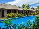 Tropical Resort Langkawi featuring a peaceful boutique resort with a long outdoor swimming pool, tropical gardens, and low-rise chalet-style accommodations in a tranquil setting near Pantai Tengah.